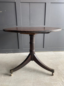 English round mahogany tilt top table on castors