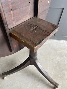 English round mahogany tilt top table on castors