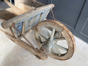 Washed out blue French wooden wheelbarrow
